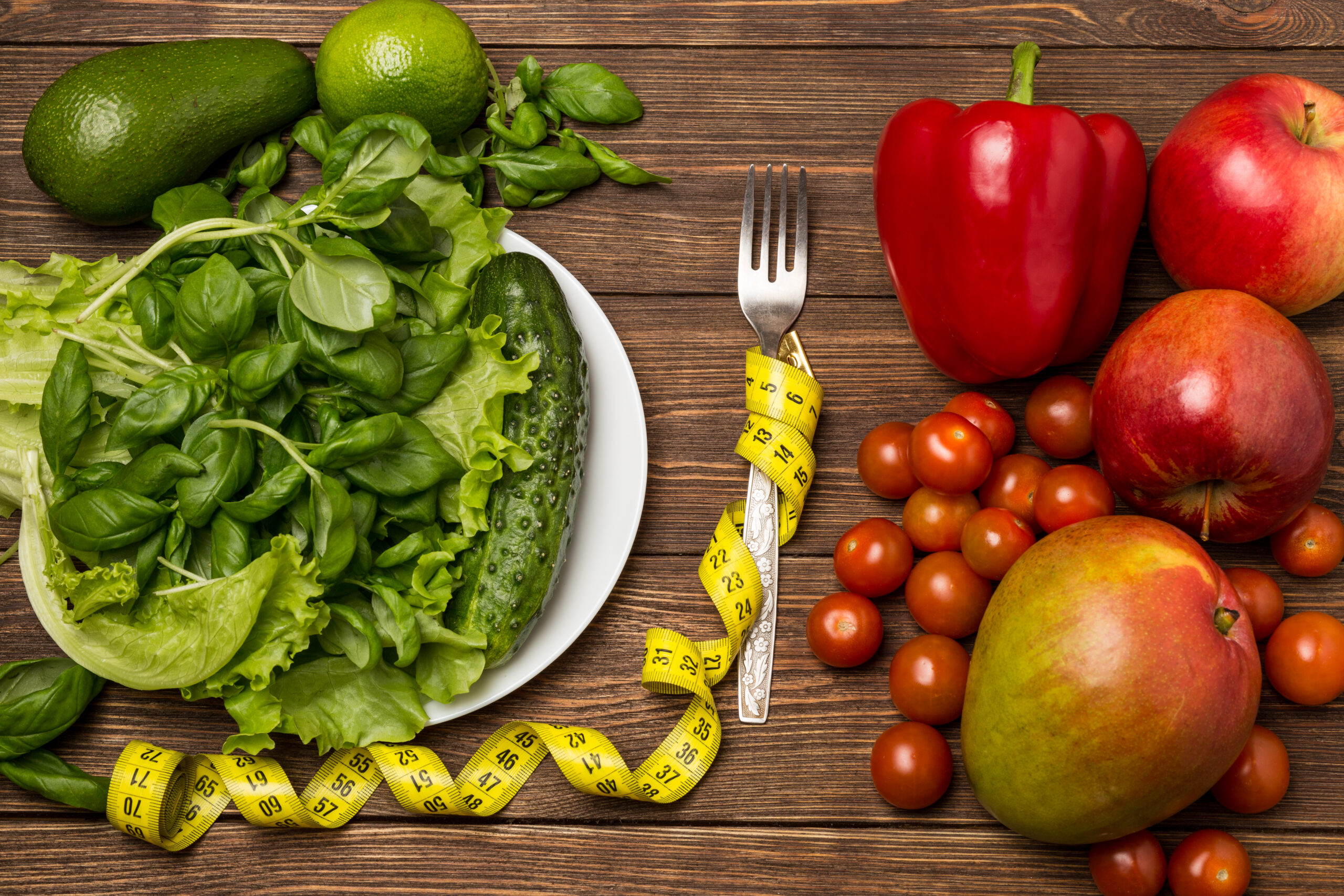 healthy eating, dieting, slimming and weigh loss concept. fruits and vegetables on wooden background with space for text. vegetarian food